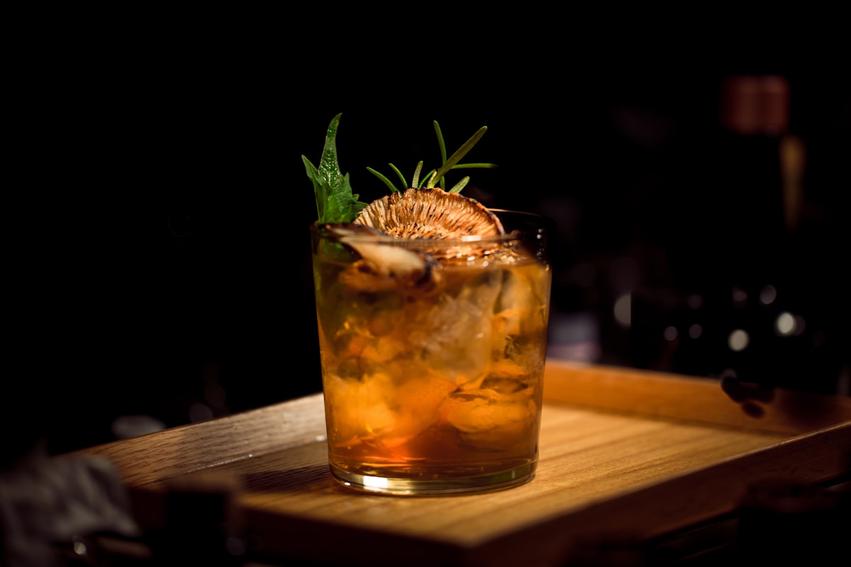 Car keys beside an alcoholic drink, illustrating how a DUI affects car insurance coverage