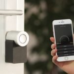 Burglar's gloved hand opening a window, illustrating homeowners insurance theft coverage